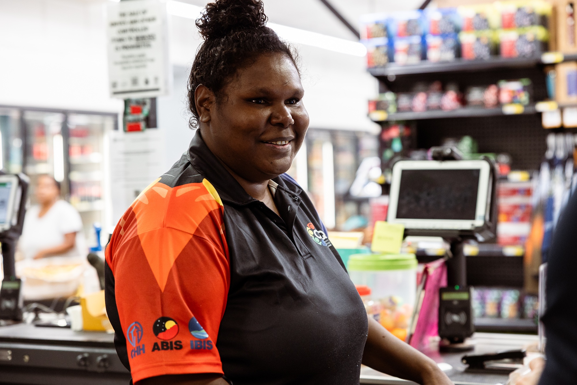 A lady at the cash register in a supermarket