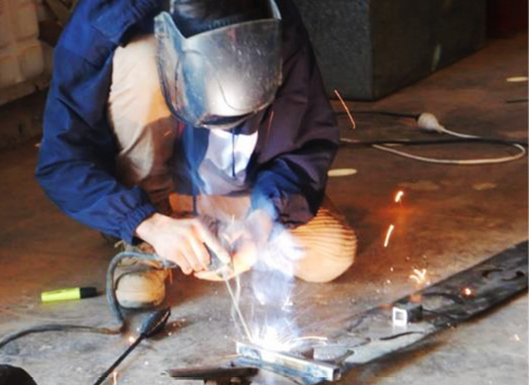 An Indigenous ranger doing welding